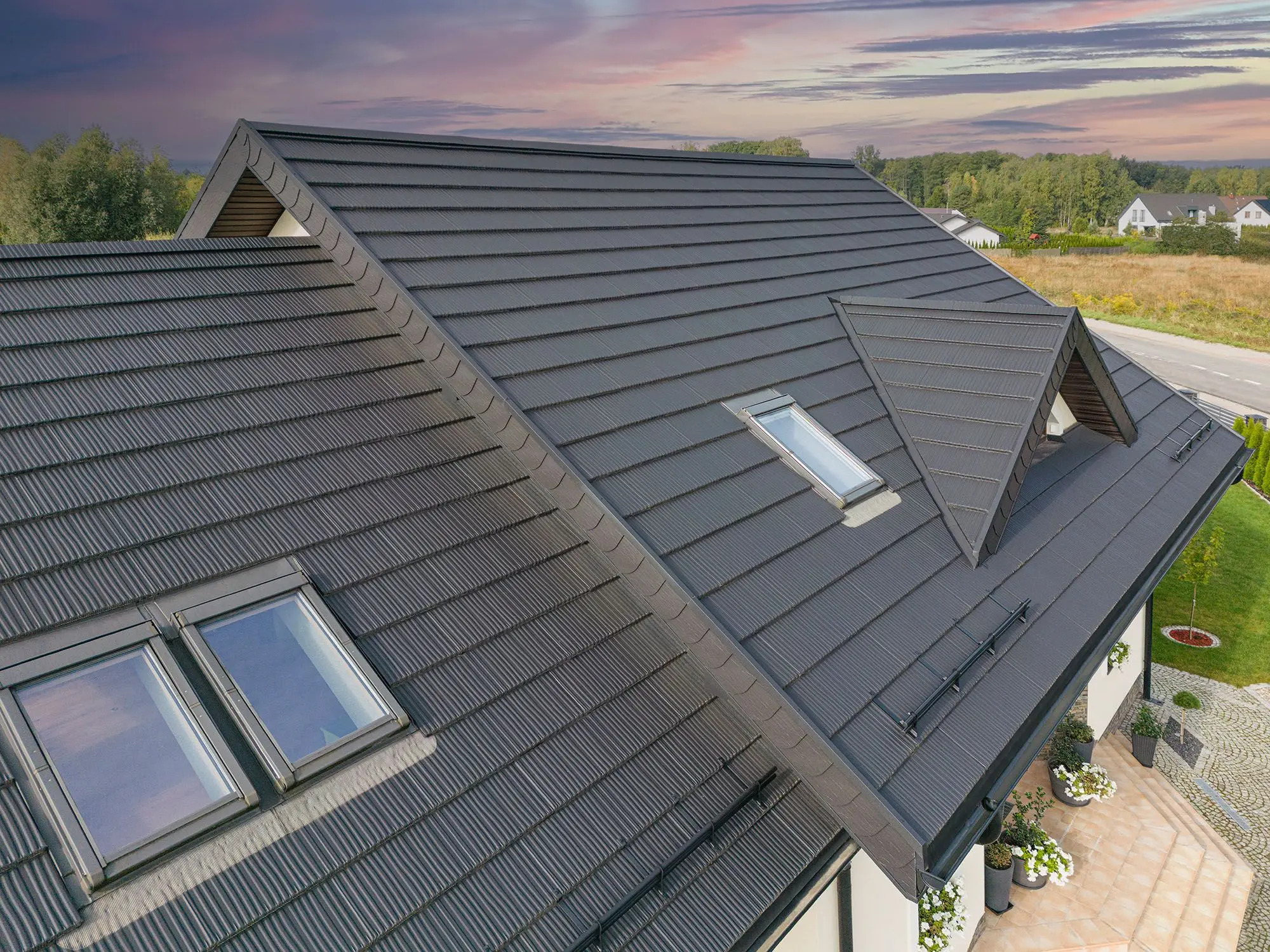 Single-family house covered with metal roof tiles imitating wood shingles (source: Pruszyński)